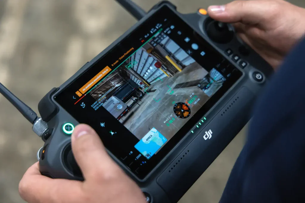 Student operating DJI controller during training.