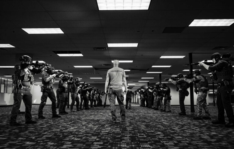 SWAT instructor guiding operators through weapons flow drills during a basic SWAT training course