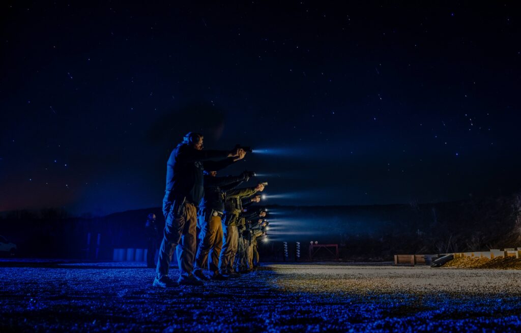 Students practicing red dot sight acquisition during low light RDS instructor training