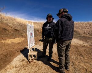 High Threat Training Group instructor discussing LPVO holdover patterns with students during instructor course