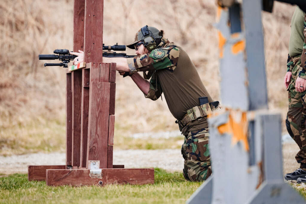 Student at HTTG LPVO training course practicing tactical shooting around a barricade with a patrol rifle.