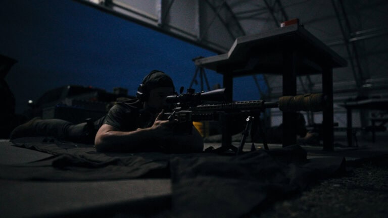 Law enforcement student practicing low-light techniques during a basic sniper course in Searsboro, Iowa.